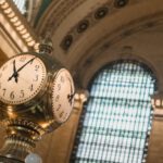 Heritage Railways - From below of vintage golden clock placed in hallway with aged interior with ornamental walls and windows and high ceilings placed in Grand Central Terminal in New Your City in daytime