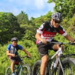 Day At The Races - Three Men Riding on Bicycles