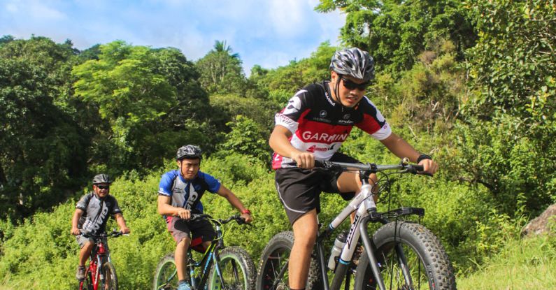 Day At The Races - Three Men Riding on Bicycles