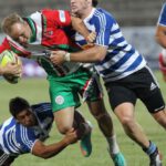 Rugby Stadiums - Man in Blue and White Striped Soccer Jersey Playing Rugby