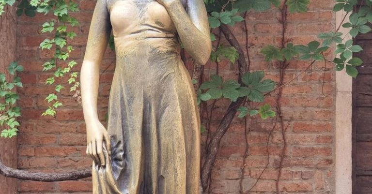 Shakespeare - Metal Statue of Juliet by a Brick Wall with a Creeper Plant