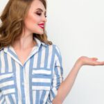 Fashion Shows - Woman in Blue and White Striped Top Raising Her Left Hand