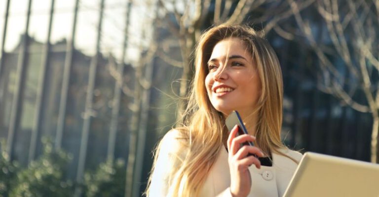 Fashion Schools - Woman Wearing White Top Holding Smartphone and Tablet