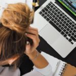 Studying - Woman Sitting in Front of Macbook