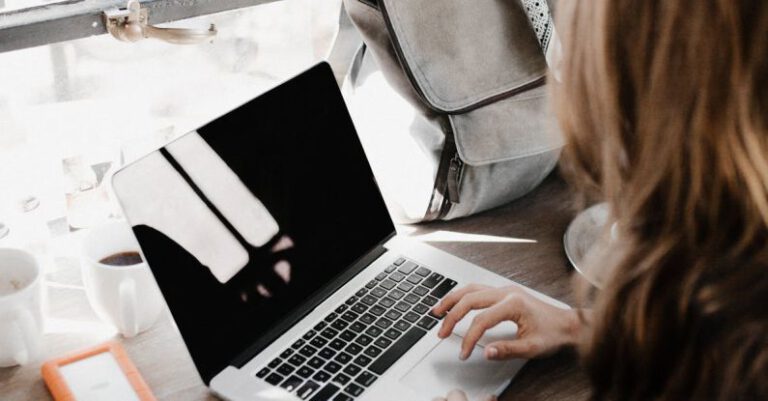 Work And Study - Close-up Photography of Woman Sitting Beside Table While Using Macbook