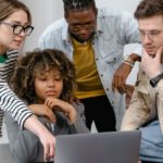 Tech Entrepreneurs - A Group of People Planning while Looking at the Laptop