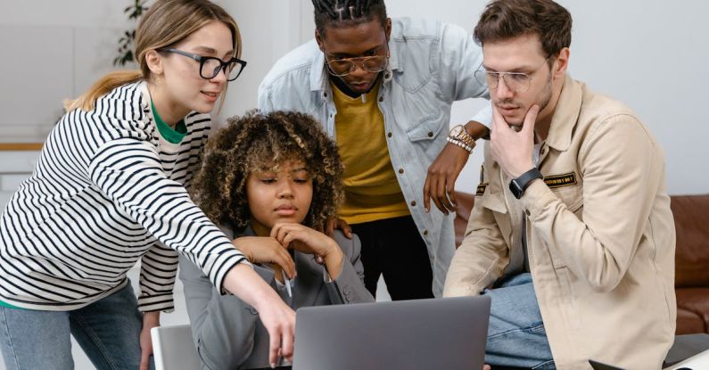 Tech Entrepreneurs - A Group of People Planning while Looking at the Laptop