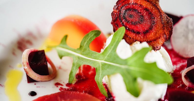 British Dishes - Sliced Beetroot On a Plate topped with Green Leaf