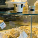 Bakeries - A bakery counter with various types of bread and pastries