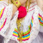 Folklore - Selective Focus Photography of Woman Holding Floral Hairpiece