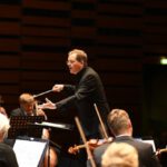 Classical Concert - Orchestra and Conductor During the Performance