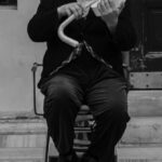 Comedy Festivals - A man in top hat and cane playing violin