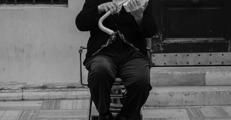 Comedy Festivals - A man in top hat and cane playing violin