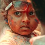 Family Festivals - A child with paint on her face and a man