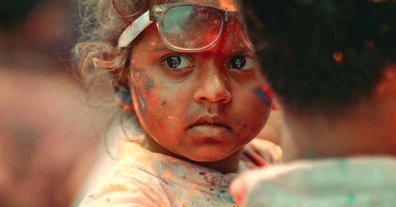 Family Festivals - A child with paint on her face and a man