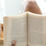 Wellness Retreats - Woman reading book in bathtub during spa procedures