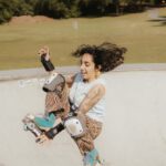 Outdoor Activities - Woman in Roller Skates Jumping